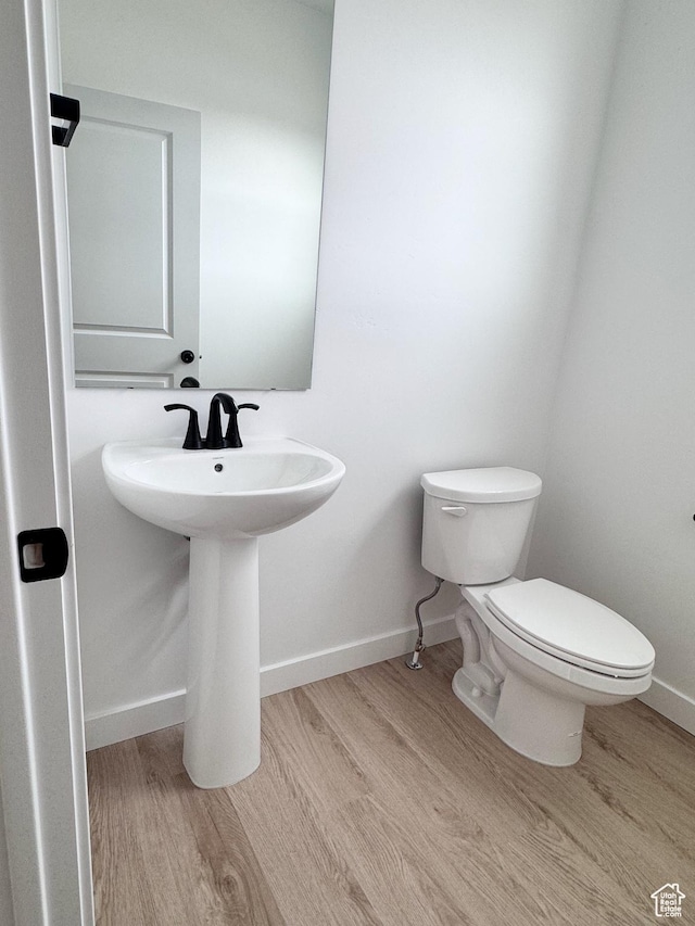 189 N Woodrun Way Unit 131, Saratoga Springs, UT 84045 - half bathroom featuring wood finished floors, toilet, and baseboards