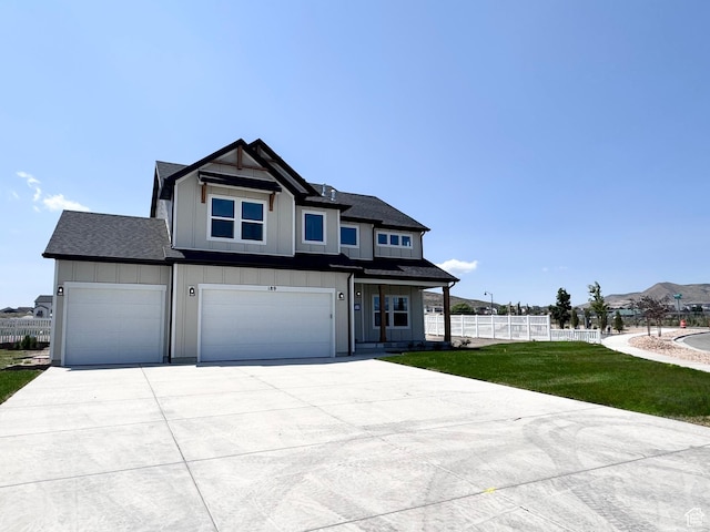 189 N Woodrun Way Unit 131, Saratoga Springs, UT 84045 - view of front facade featuring board and batten siding, driveway, a garage, and a shingled roof