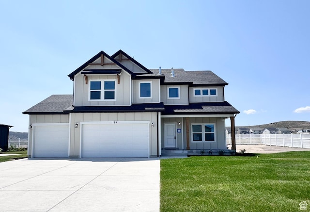 189 N Woodrun Way Unit 131, Saratoga Springs, UT 84045 - view of front of house with board and batten siding, concrete driveway, a garage, and a shingled roof