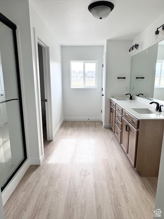 189 N Woodrun Way Unit 131, Saratoga Springs, UT 84045 - bathroom with wood finished floors, double vanity, and baseboards