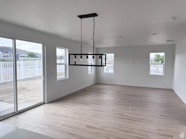 189 N Woodrun Way Unit 131, Saratoga Springs, UT 84045 - unfurnished dining area featuring light wood-type flooring and baseboards