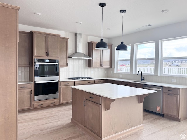 189 N Woodrun Way Unit 131, Saratoga Springs, UT 84045 - kitchen with stainless steel appliances, wall chimney exhaust hood, light wood-style floors, and a sink