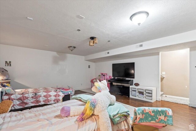2099 E Hickock Way, Eagle Mountain, UT 84005 - bedroom featuring a textured ceiling, wood finished floors, and baseboards