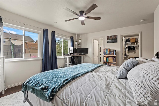2099 E Hickock Way, Eagle Mountain, UT 84005 - bedroom with wood finished floors, baseboards, a closet, a spacious closet, and ceiling fan
