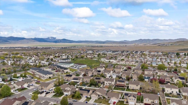 2099 E Hickock Way, Eagle Mountain, UT 84005 - aerial view of property and surrounding area with a mountain backdrop and nearby suburban area
