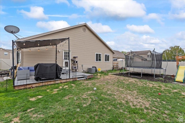 2099 E Hickock Way, Eagle Mountain, UT 84005 - back of house with a trampoline, central air condition unit, an outdoor living space, and a wooden deck