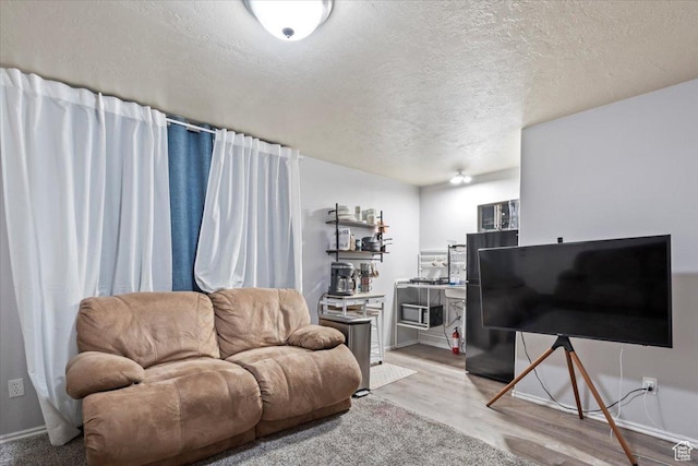 2099 E Hickock Way, Eagle Mountain, UT 84005 - living area with wood finished floors, a textured ceiling, and baseboards