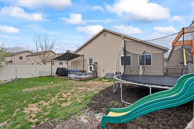 2099 E Hickock Way, Eagle Mountain, UT 84005 - back of property featuring a trampoline, an outdoor hangout area, and a patio