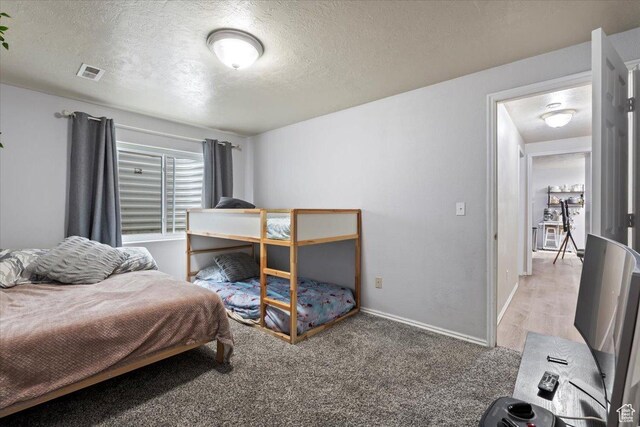 2099 E Hickock Way, Eagle Mountain, UT 84005 - carpeted bedroom with a textured ceiling and baseboards