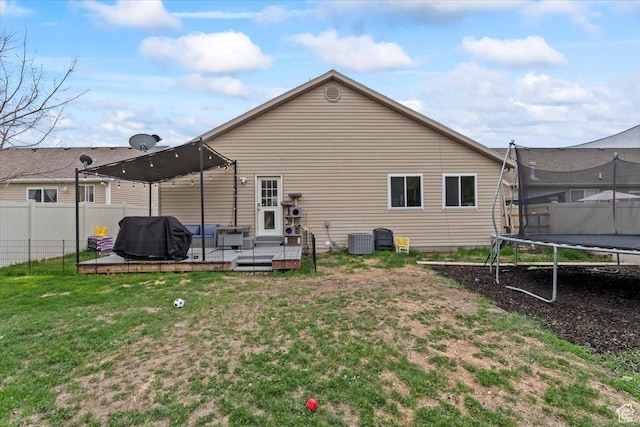 2099 E Hickock Way, Eagle Mountain, UT 84005 - rear view of house featuring a trampoline, cooling unit, a deck, and an outdoor living space
