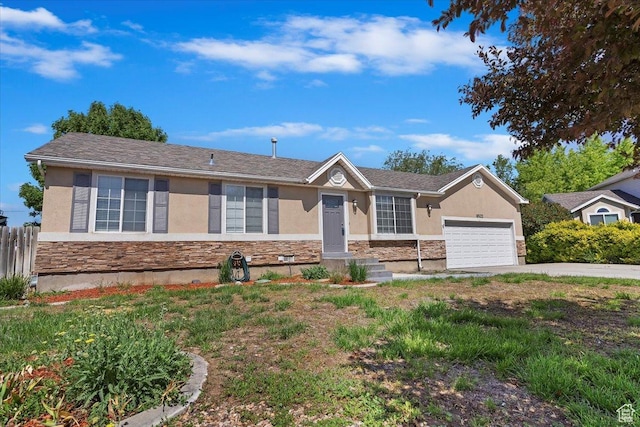 8522 S Kolby Ln, Midvale, UT 84047 - ranch-style house with stucco siding, stone siding, a garage, and concrete driveway
