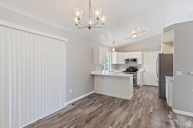 8522 S Kolby Ln, Midvale, UT 84047 - kitchen featuring appliances with stainless steel finishes, a peninsula, dark wood finished floors, vaulted ceiling, and a chandelier