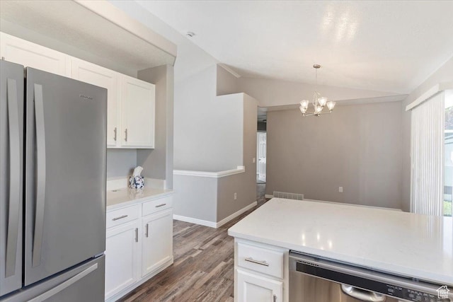 8522 S Kolby Ln, Midvale, UT 84047 - kitchen with stainless steel appliances, lofted ceiling, white cabinets, a chandelier, and light wood finished floors