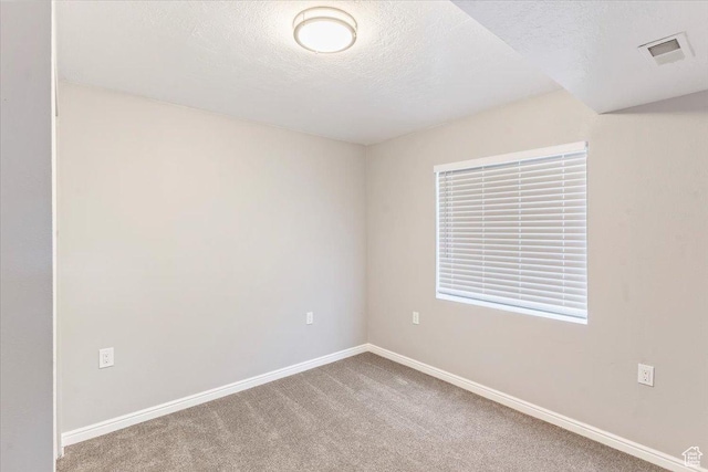 8522 S Kolby Ln, Midvale, UT 84047 - unfurnished room with a textured ceiling, baseboards, and carpet flooring