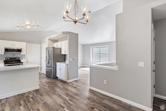 8522 S Kolby Ln, Midvale, UT 84047 - kitchen with stainless steel appliances, lofted ceiling, white cabinetry, light countertops, and baseboards