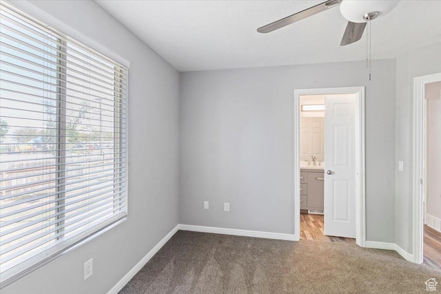 8522 S Kolby Ln, Midvale, UT 84047 - unfurnished bedroom featuring carpet flooring, multiple windows, baseboards, and ensuite bathroom