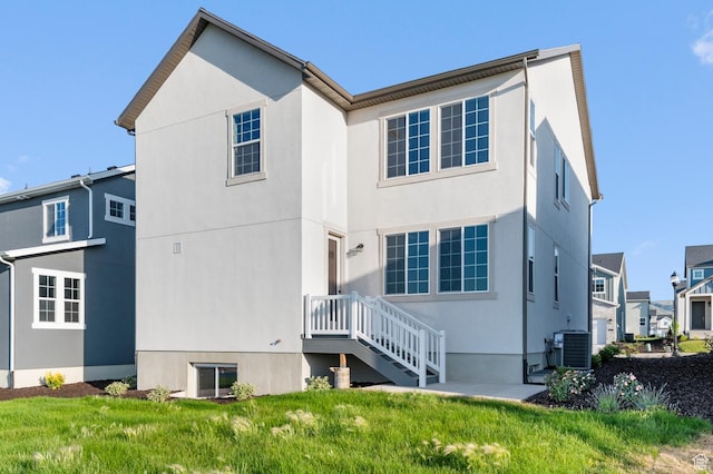 6644 W Spring Snow Ln, Herriman, UT 84096 - rear view of property with stucco siding, a residential view, and a lawn
