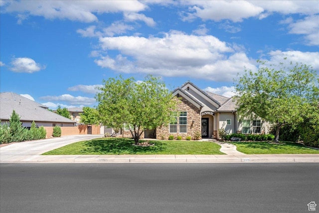 2379 E Crimson Dr, St George, UT 84790 - view of front of home featuring a tile roof, stucco siding, stone siding, and a front yard