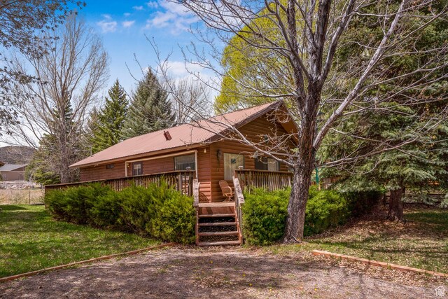 786 W Carter Dr, Pine Valley, UT 84781 - view of front of house featuring a deck, metal roof, and a front yard