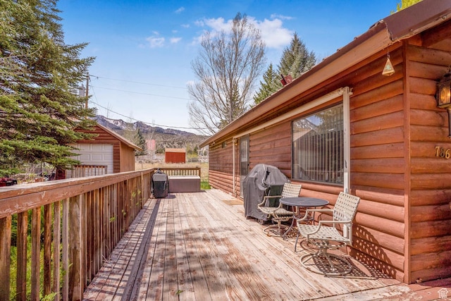 786 W Carter Dr, Pine Valley, UT 84781 - wooden terrace featuring a detached garage, an outdoor structure, and grilling area