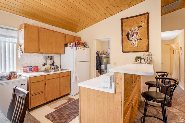 786 W Carter Dr, Pine Valley, UT 84781 - kitchen featuring wood ceiling, strapped water heater, a sink, freestanding refrigerator, and a peninsula