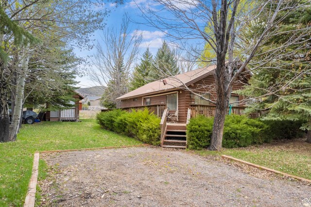 786 W Carter Dr, Pine Valley, UT 84781 - exterior space with a front lawn, a wooden deck, and log siding