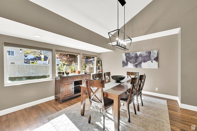 2974 N 1375 E, North Ogden, UT 84414 - dining space featuring a high ceiling, an inviting chandelier, baseboards, wood finished floors, and visible vents