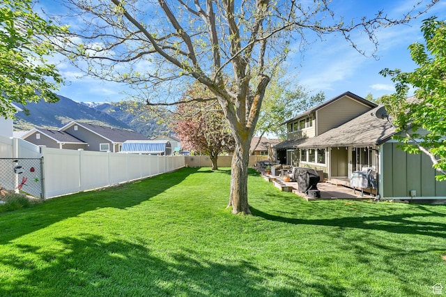 2974 N 1375 E, North Ogden, UT 84414 - view of yard with a fenced backyard, a patio area, and a mountain view