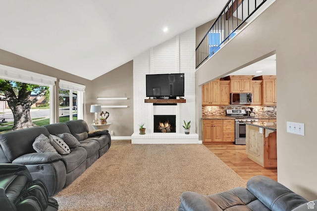 2974 N 1375 E, North Ogden, UT 84414 - living area featuring light wood-style floors, recessed lighting, a fireplace, and high vaulted ceiling