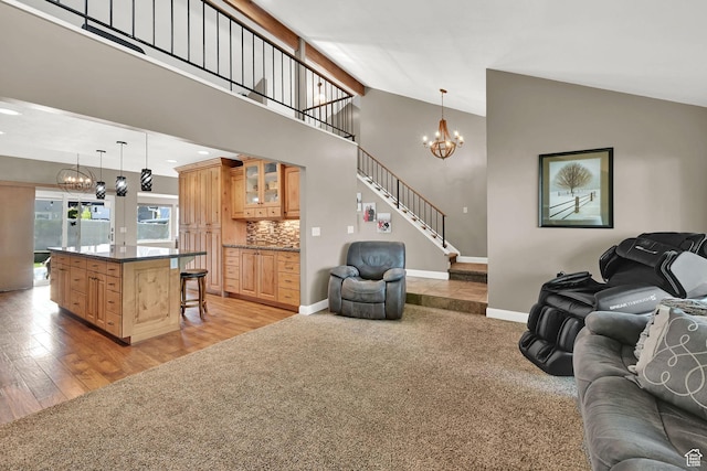 2974 N 1375 E, North Ogden, UT 84414 - living area featuring baseboards, high vaulted ceiling, an inviting chandelier, light carpet, and stairs