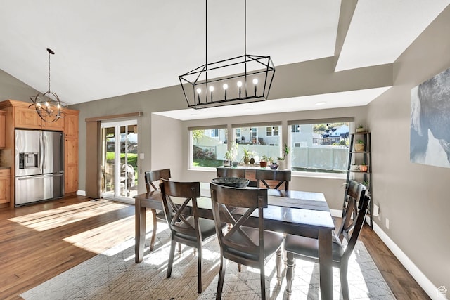 2974 N 1375 E, North Ogden, UT 84414 - dining space featuring an inviting chandelier, baseboards, vaulted ceiling, and wood finished floors
