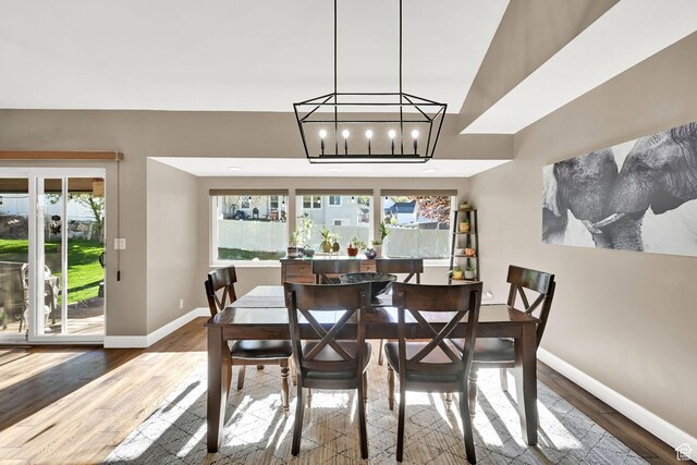 2974 N 1375 E, North Ogden, UT 84414 - dining room featuring baseboards, an inviting chandelier, a healthy amount of sunlight, and wood finished floors