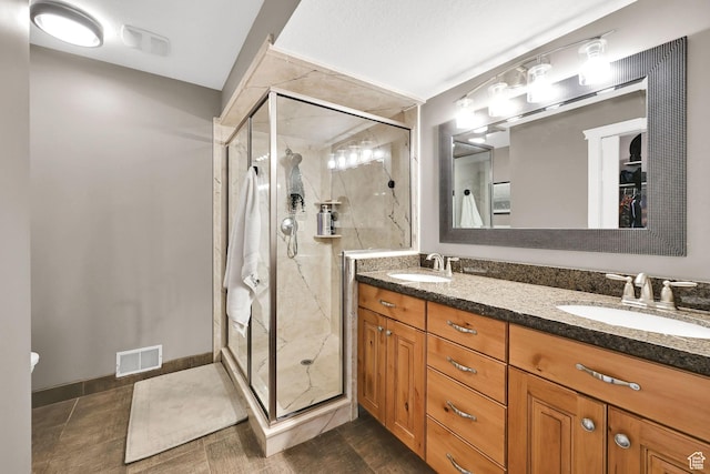 2974 N 1375 E, North Ogden, UT 84414 - full bathroom with double vanity, visible vents, a marble finish shower, and a sink