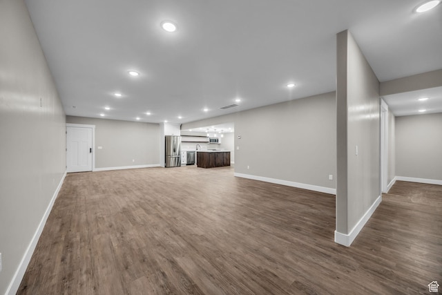 1138 N 1000 E, Mapleton, UT 84664 - unfurnished living room featuring baseboards, dark wood finished floors, and recessed lighting
