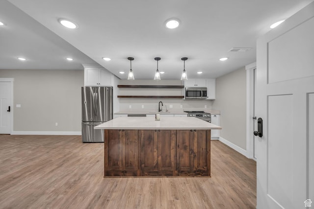 1138 N 1000 E, Mapleton, UT 84664 - kitchen with stainless steel appliances, a sink, open shelves, light countertops, and baseboards