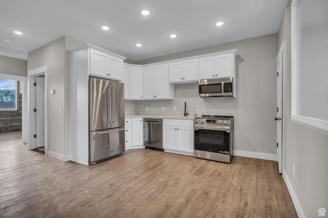 1138 N 1000 E, Mapleton, UT 84664 - kitchen with appliances with stainless steel finishes, white cabinets, light wood finished floors, light countertops, and recessed lighting
