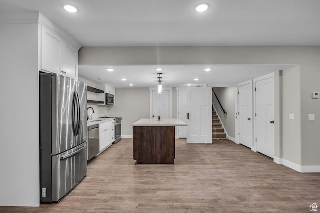 1138 N 1000 E, Mapleton, UT 84664 - kitchen with appliances with stainless steel finishes, a sink, a kitchen island, light countertops, and white cabinets