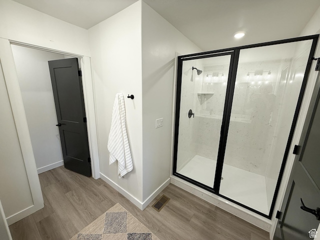 3656 S 4600 W Unit 220, West Haven, UT 84401 - bathroom featuring baseboards, visible vents, a shower stall, and wood finished floors