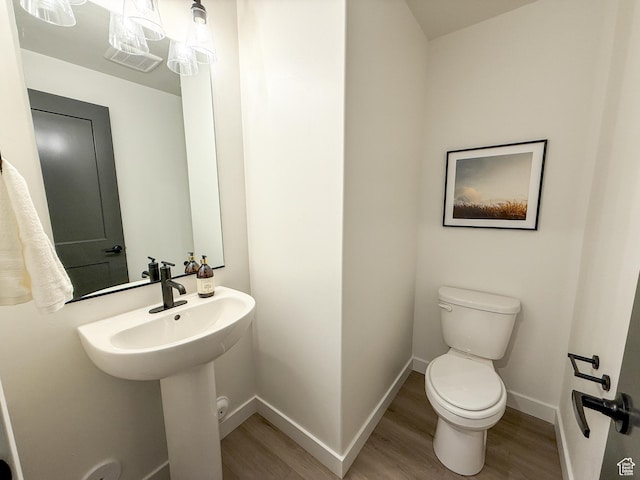 3656 S 4600 W Unit 220, West Haven, UT 84401 - bathroom with baseboards, toilet, and wood finished floors