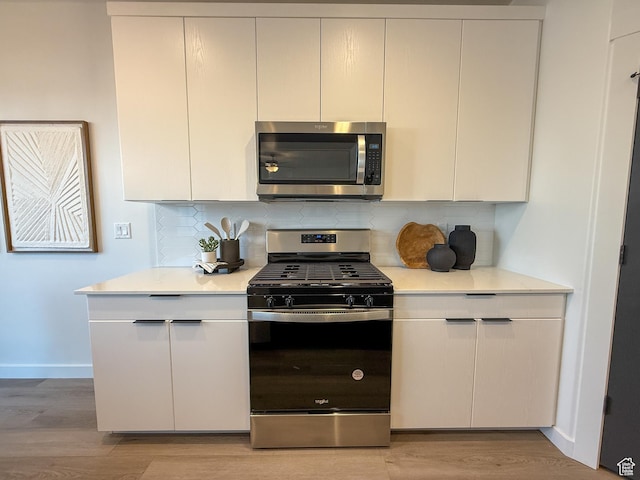 3656 S 4600 W Unit 220, West Haven, UT 84401 - kitchen featuring light countertops, baseboards, stainless steel appliances, and light wood finished floors