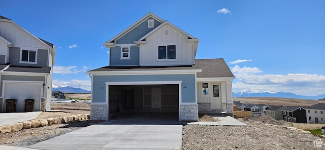 9814 N Bridge, Eagle Mountain, UT 84005 - craftsman house featuring a mountain view, concrete driveway, board and batten siding, stone siding, and an attached garage