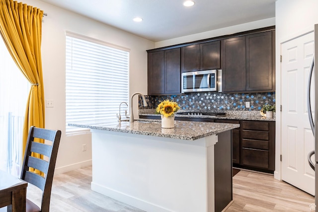 13021 S Bilston Ln, Herriman, UT 84096 - kitchen featuring plenty of natural light, appliances with stainless steel finishes, and light stone countertops