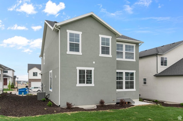 6641 W Spring Snow Ln, Herriman, UT 84096 - rear view of property featuring stucco siding and a yard