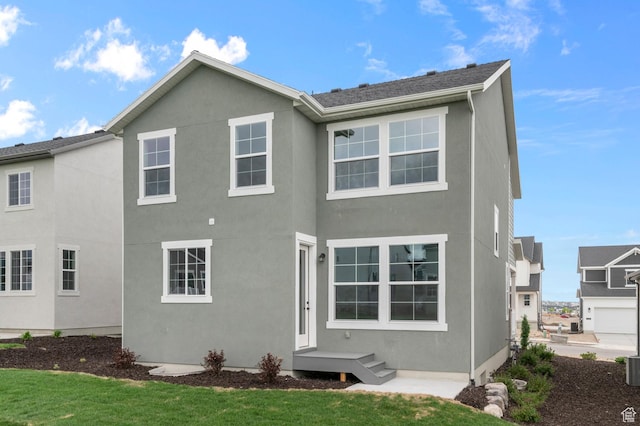 6641 W Spring Snow Ln, Herriman, UT 84096 - rear view of property with stucco siding and a yard