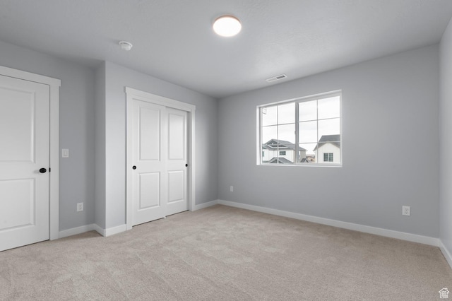 6641 W Spring Snow Ln, Herriman, UT 84096 - unfurnished bedroom featuring carpet flooring, baseboards, and a closet