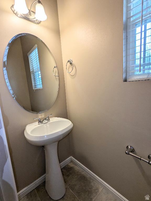 bathroom with baseboards and tile patterned flooring
