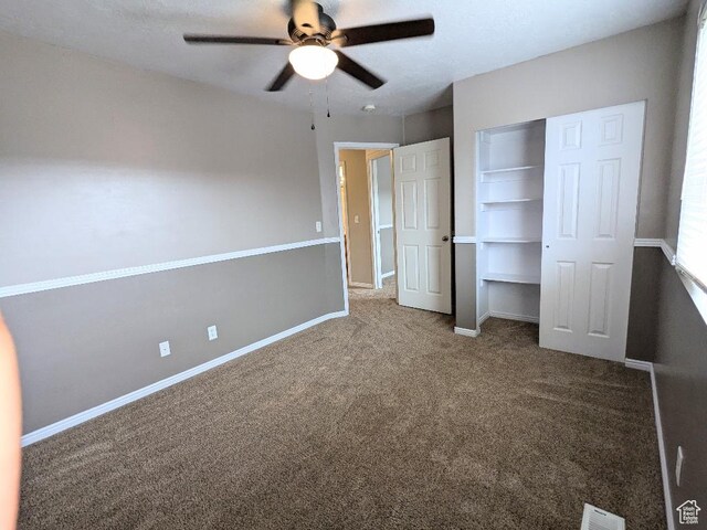 unfurnished bedroom with baseboards, carpet, a closet, and visible vents