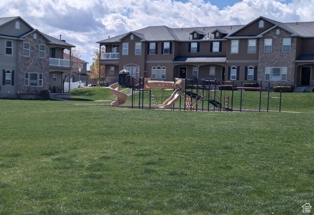 communal playground with a lawn and a residential view
