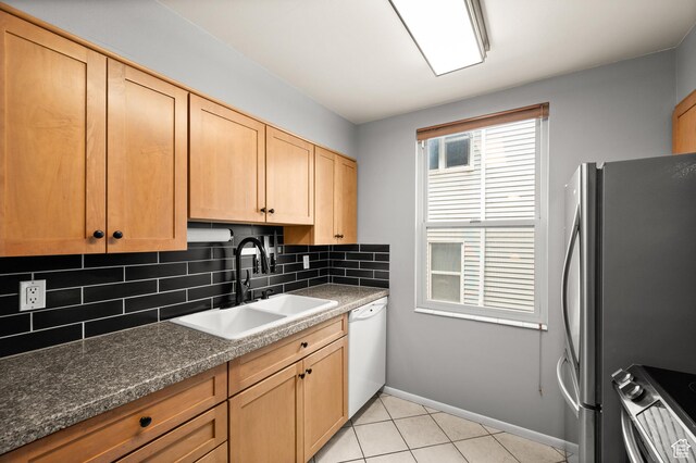 229 N B St Unit 4, Salt Lake City, UT 84103 - kitchen with white dishwasher, tasteful backsplash, stove, a sink, and freestanding refrigerator
