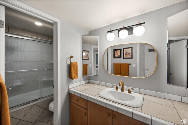 229 N B St Unit 4, Salt Lake City, UT 84103 - full bath featuring vanity, visible vents, toilet, tile patterned floors, and a stall shower